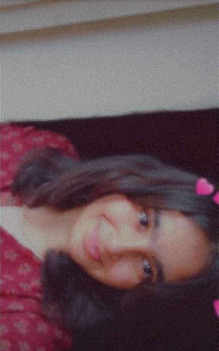 Shruti smiling in a pink outfit