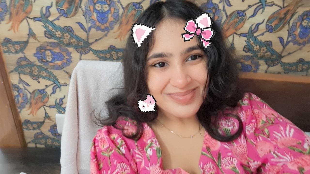 Shruti smiling with a playful photo filter