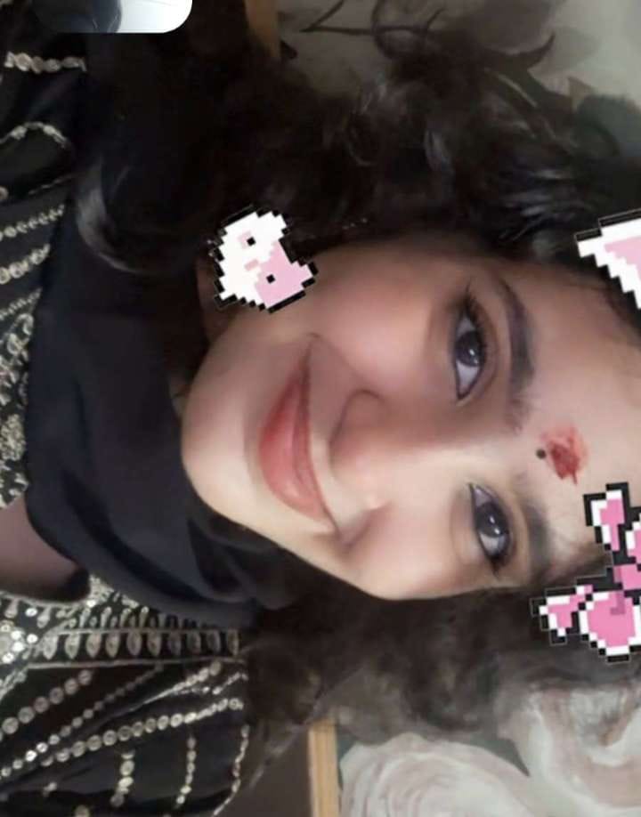 Shruti smiling with little pixel hearts